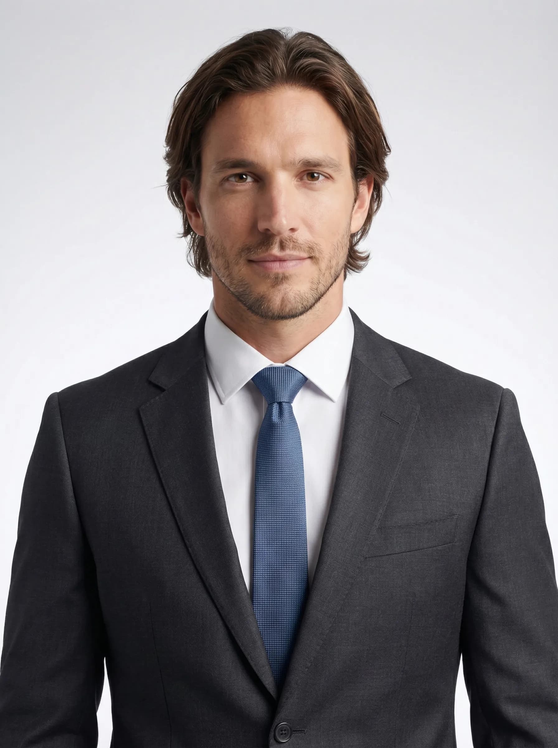 Professional consultant headshot in tailored charcoal suit